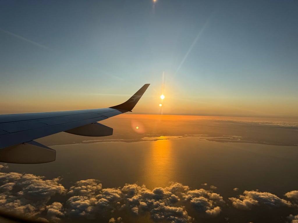 airplane window sunrise travel