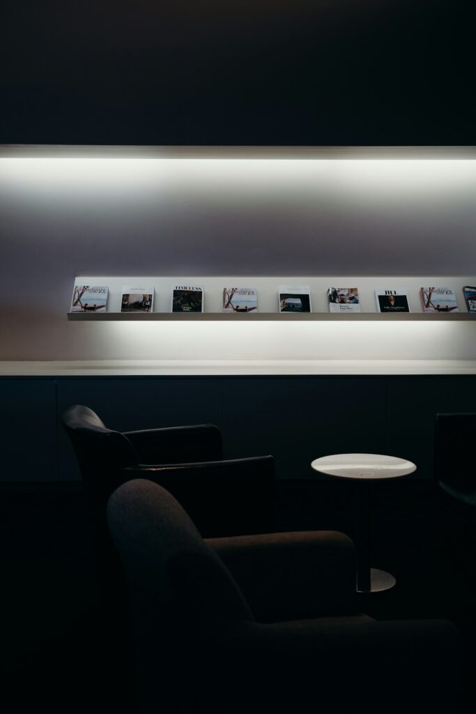 Premium airport lounge interior with comfortable seating and magazines for credit card lounge access guide