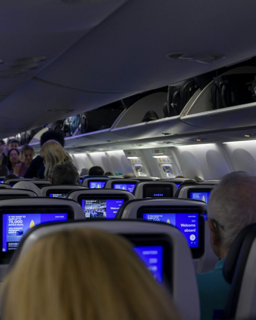Airplane cabin interior showing overhead luggage bins for Indian airline baggage rules