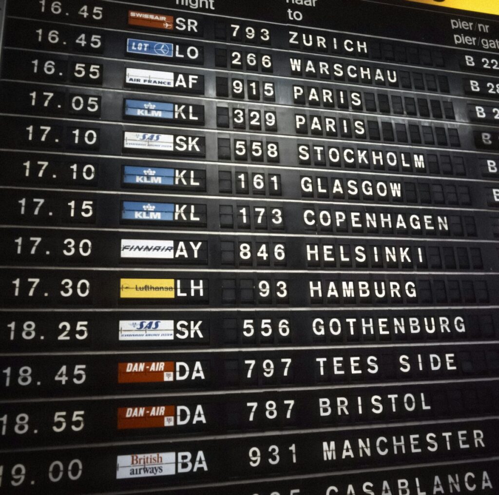 Airport departure board showing flight schedules for booking cheap flights in India