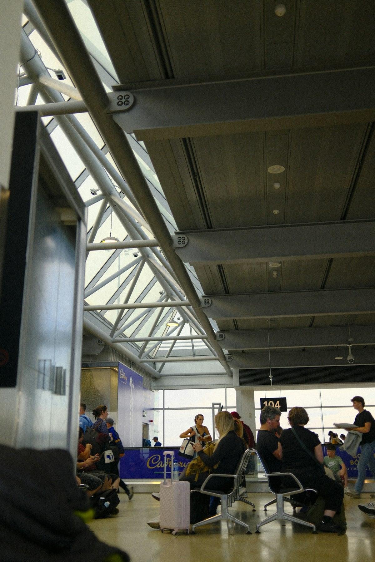 Passengers waiting at airport departure gate