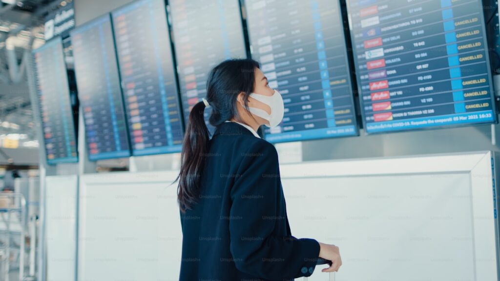 Traveler checking cancelled flights departure board for flight refund guide